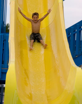 Young-boy-on-yellow-water-slide-283x357.jpg