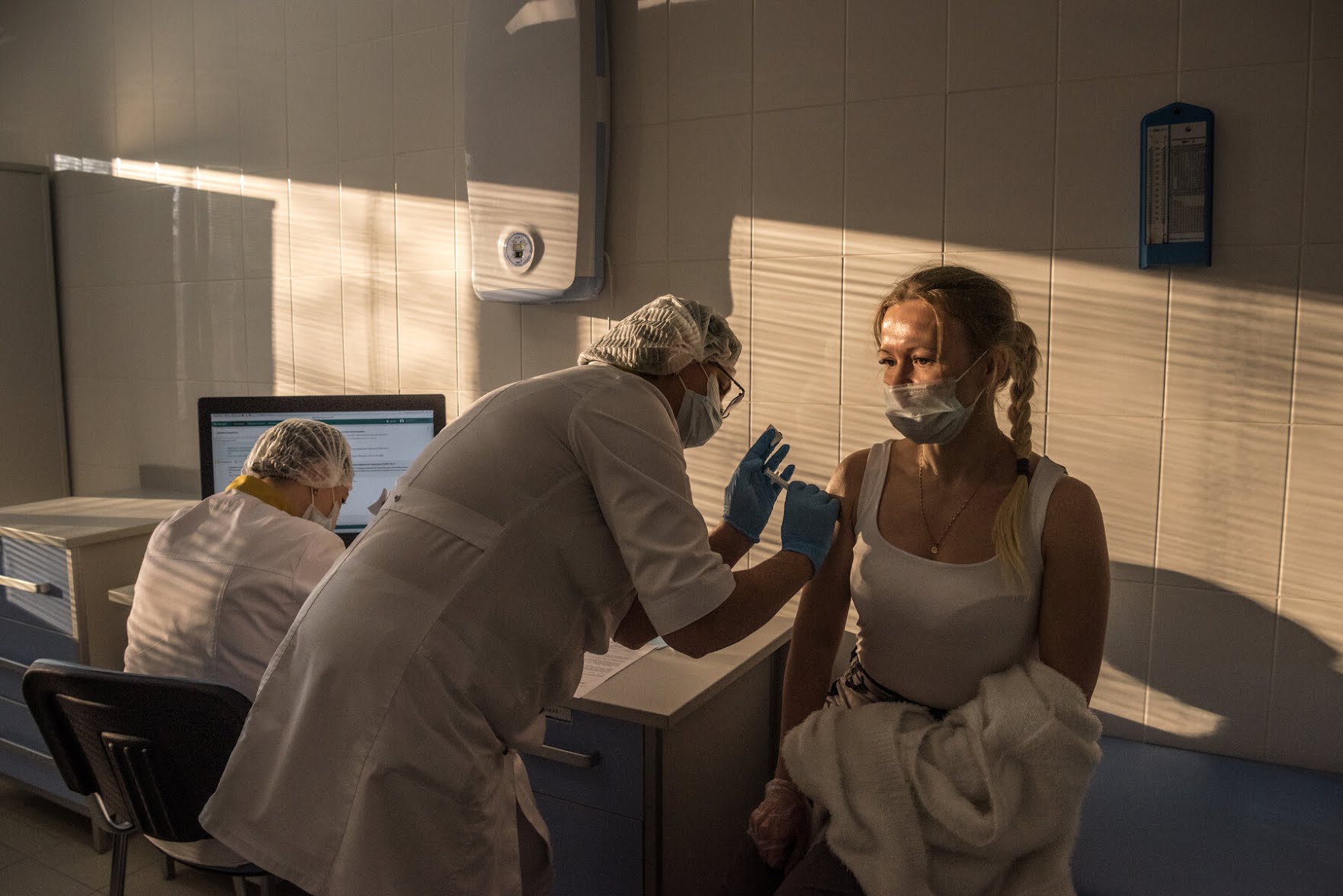 A medic inoculating a doctor with Russia’s Covid-19 vaccine, Sputnik V, at a policlinic in Moscow in early December. The leading medical journal The Lancet published this week trial results showing that Sputnik V had an efficacy rate of 91.6 percent.