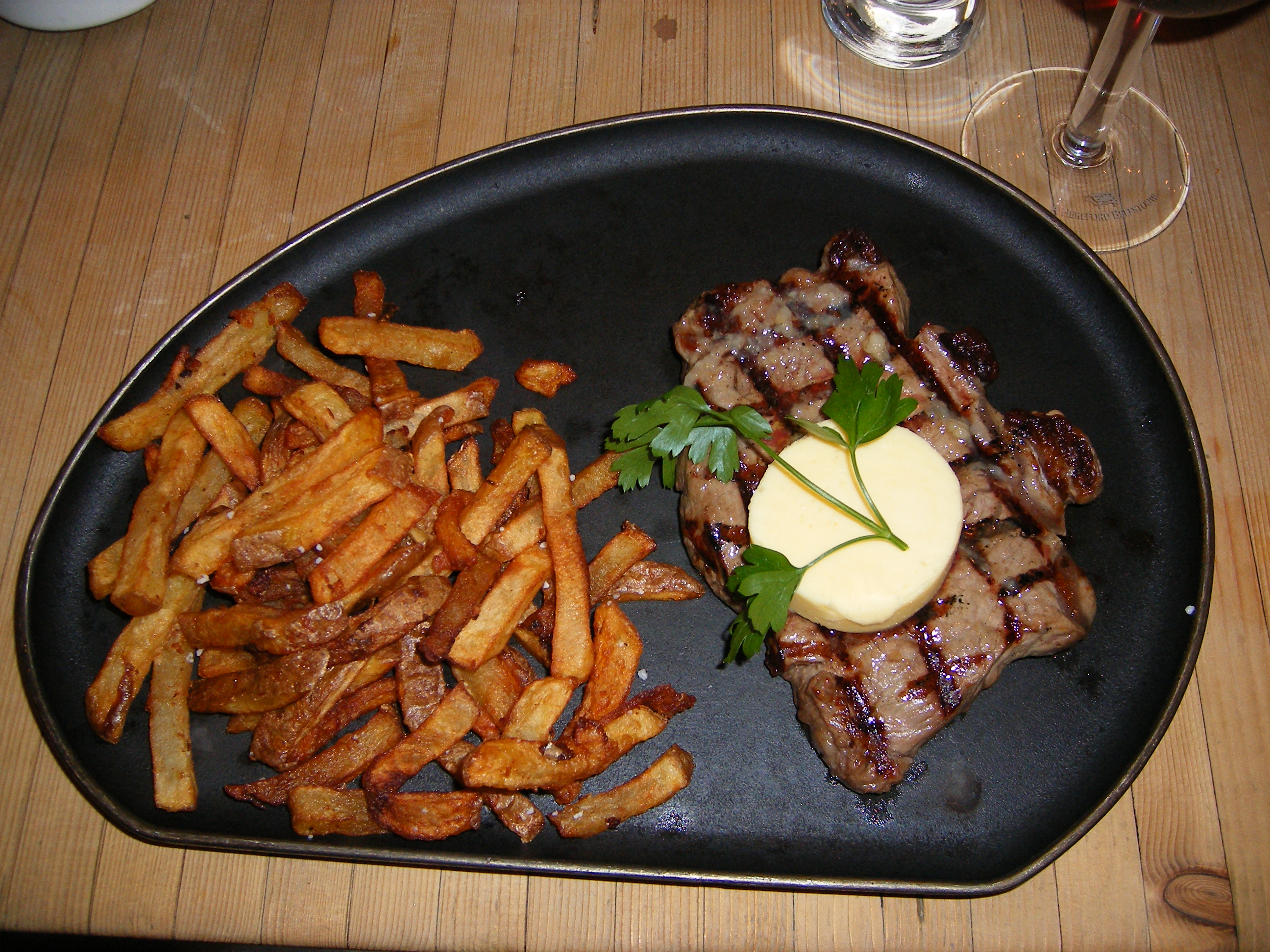 Sirloin_steak_with_garlic_butter_and_french_fries.JPG