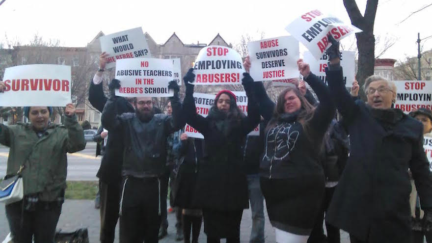 Orthodox activists, like these protesting outside a Brooklyn yeshiva on May 3, 2016, are asking institutions to do more to report and investigate allegations of child sexual and physical abuse. (Courtesy of Chaim Levin via JTA)