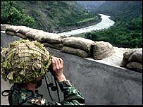 Pakistani soldier looks at Indian positions on front line 