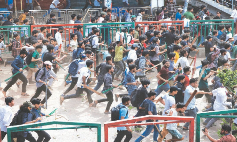 MEMBERS of the ruling party Awami League’s student wing clash with demonstrators protesting against quota for government jobs near Dhaka College, on Tuesday.—Reuters