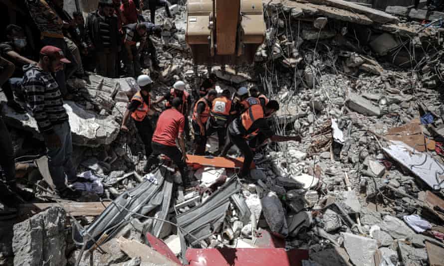 Search and rescue work continues amid the debris of a building after airstrikes by Israeli army hit buildings in al-Wehda street in Gaza City.