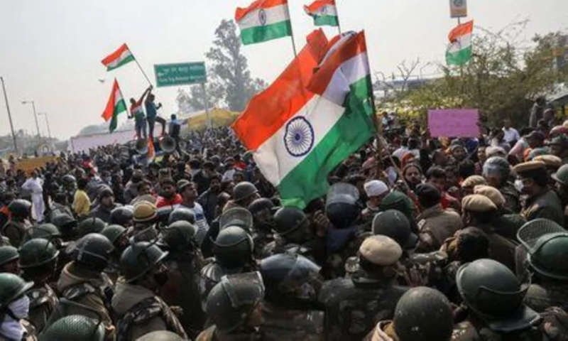 People shout anti-farmers slogans and wave India's flags as police officers try to stop them, at a site of the protest against farm laws at Singhu border near New Delhi, India, January 29. — Reuters