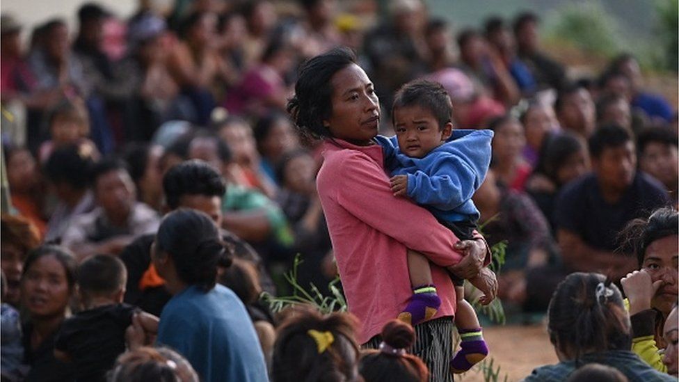 People wait at a temporary shelter in a military camp, after being evacuated by the Indian army, as they flee ethnic violence that has hit the north-eastern Indian state of Manipur on May 7, 2023