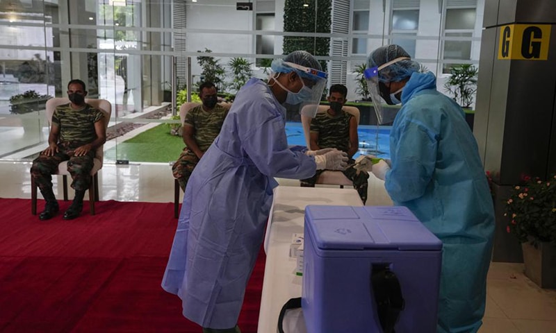 Sri Lankan army soldiers wait to receive the third jab of anti-coronavirus vaccine in Colombo, Sri Lanka on Monday. — AP