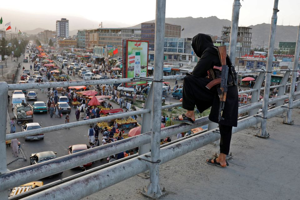 a taliban fighter stands guard on a bridge in kabul afghanistan august 6 2022 photo reuters