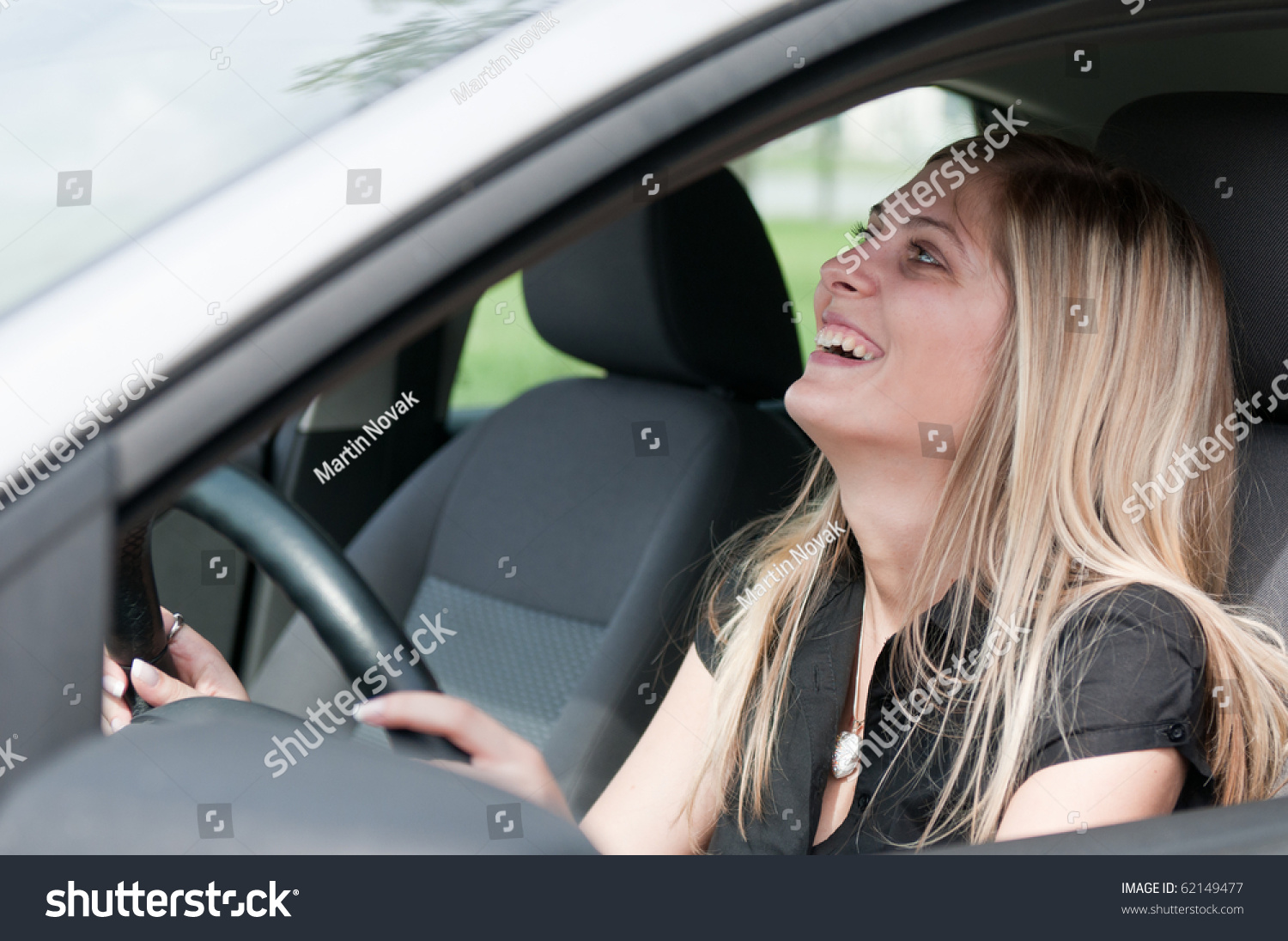 stock-photo-young-beautiful-laughing-woman-driving-car-portrait-through-side-window-62149477.jpg