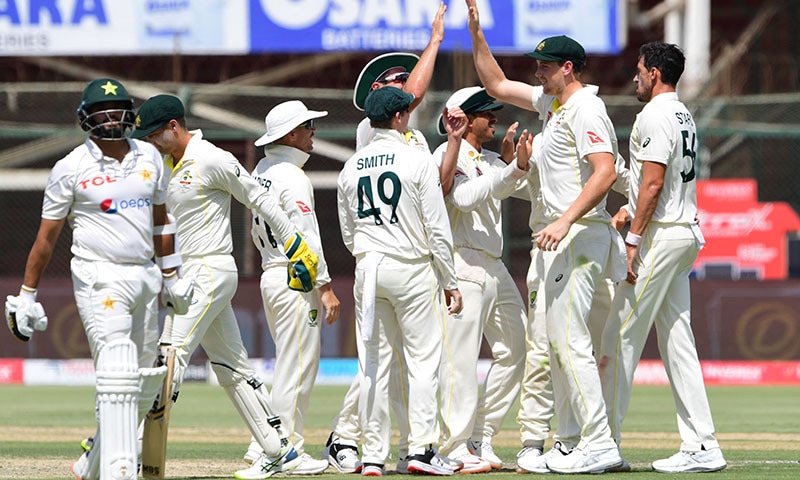 Australia's players celebrates after the dismissal of Pakistan's Azhar Ali (L) during the third day of the second Test cricket match between Pakistan and Australia at the National Cricket Stadium in Karachi on Monday. — AFP