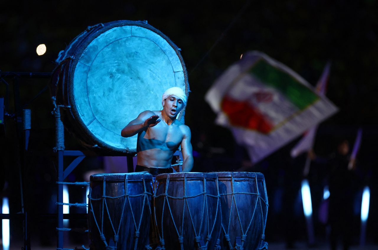 A performer plays drums during the opening ceremony.