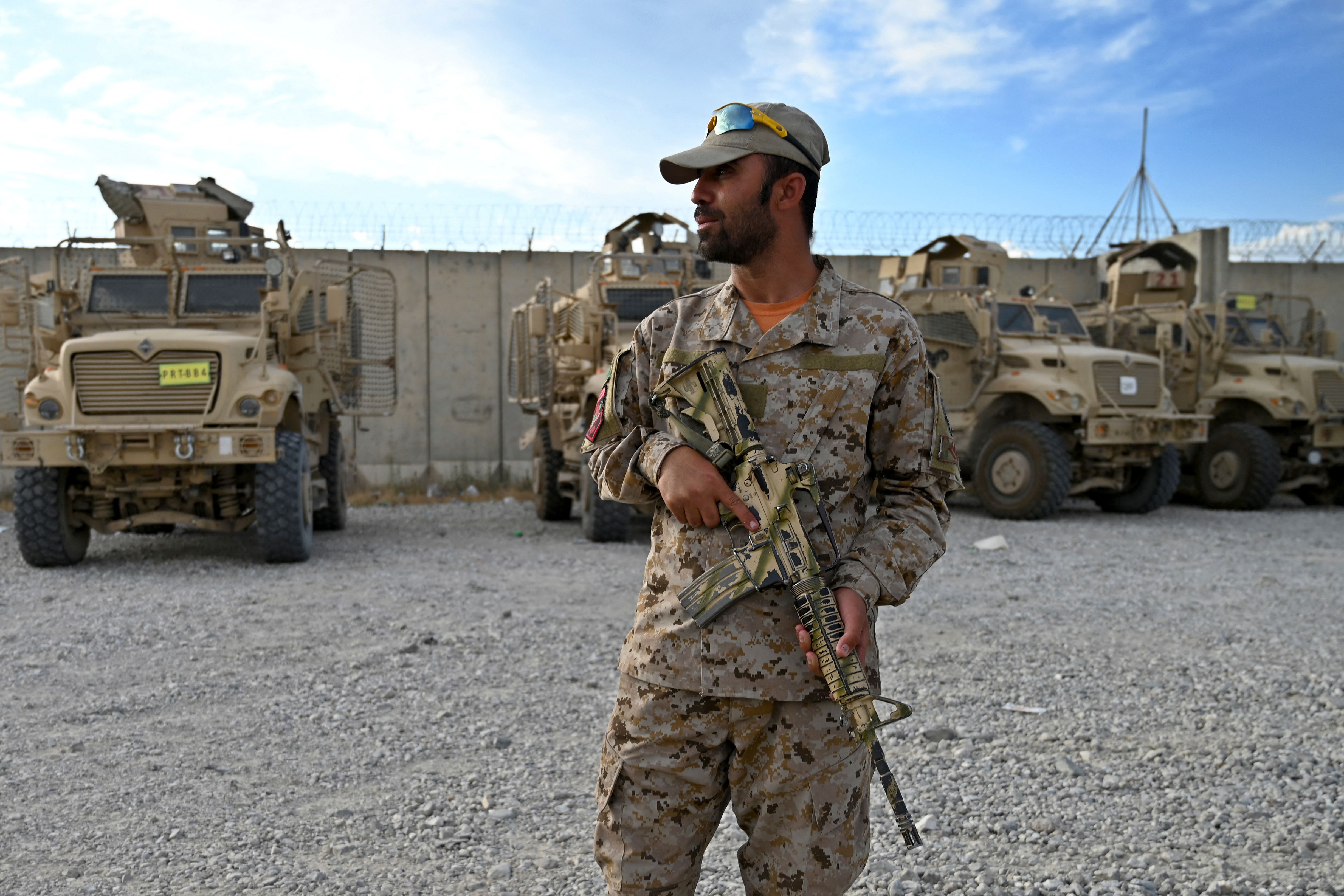 An Afghan policeman stands guard inside the Bagram US air base after troops left