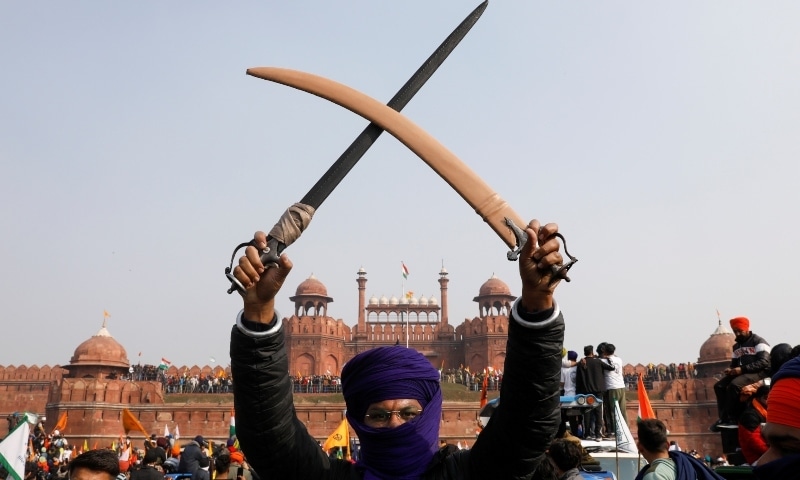 A farmer holds a sword during a protest against farm laws introduced by the government, at the historic Red Fort in Delhi, India, January 26. — Reuters