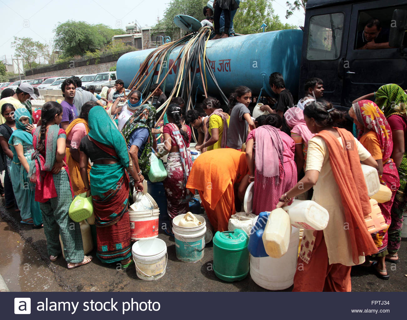 residents-of-a-locality-surround-a-water-tanker-sent-by-civic-authorities-FPTJ34.jpg