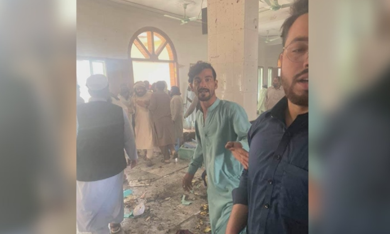 People are seen at the site of the blast in Peshawar's Dir Colony. — DawnNewsTV's Dir Colony. — DawnNewsTV
