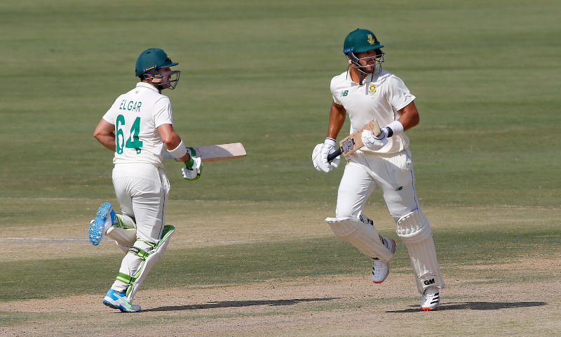 Dean Elgar, left, and Aiden Markram run between the wickets during the third day of the first cricket Test match between Pakistan and South Africa at the National Stadium in Karachi on Thursday. — AP