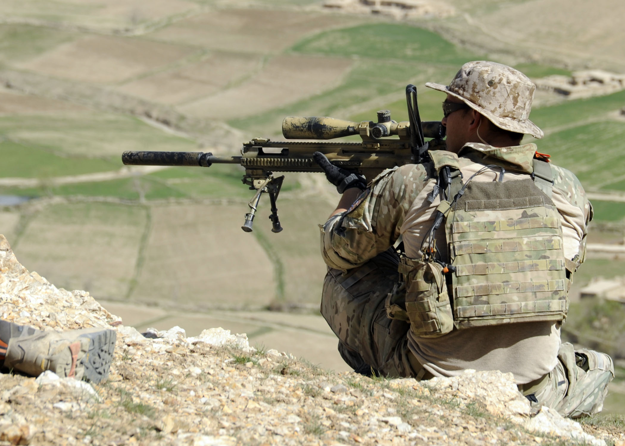 A_coalition_Special_Operations_Forces_member_fires_his_sniper_rifle_from_a_hilltop_during_a_firefight_near_Nawa_Garay_village_%28120403-N-MY805-202%29.jpg