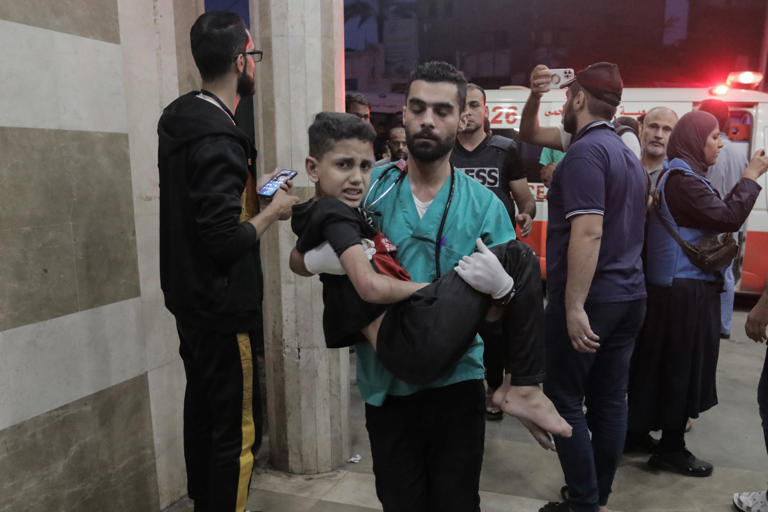 Palestinians injured in Israeli raids arrive at Nasser Medical Hospital on Tuesday in Khan Younis, Gaza.