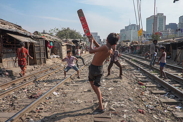 children-play-cricket-between-passing-trains-at-kaoran-bazar-railway-slum-dhaka-bangladesh.jpg