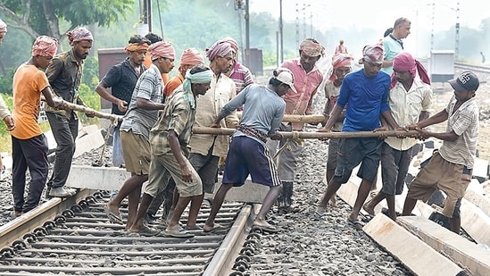 Workers restore railway tracks at the site of collision in Odisha’s Balasore district on Tuesday. (PTI)