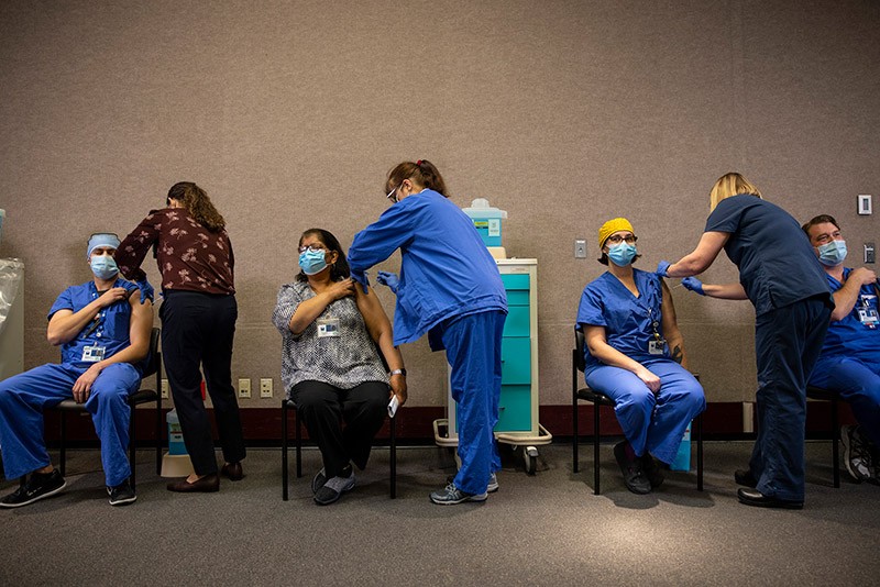 Health-care workers get the Pfizer-BioNTech COVID-19 vaccination in Portland, Oregon.