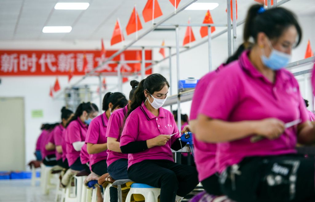 Workers at an electronics factory in in Aketao County, Xinjiang, work as part of the 'poverty alleviation' programme - or so the Chinese Communist party claims