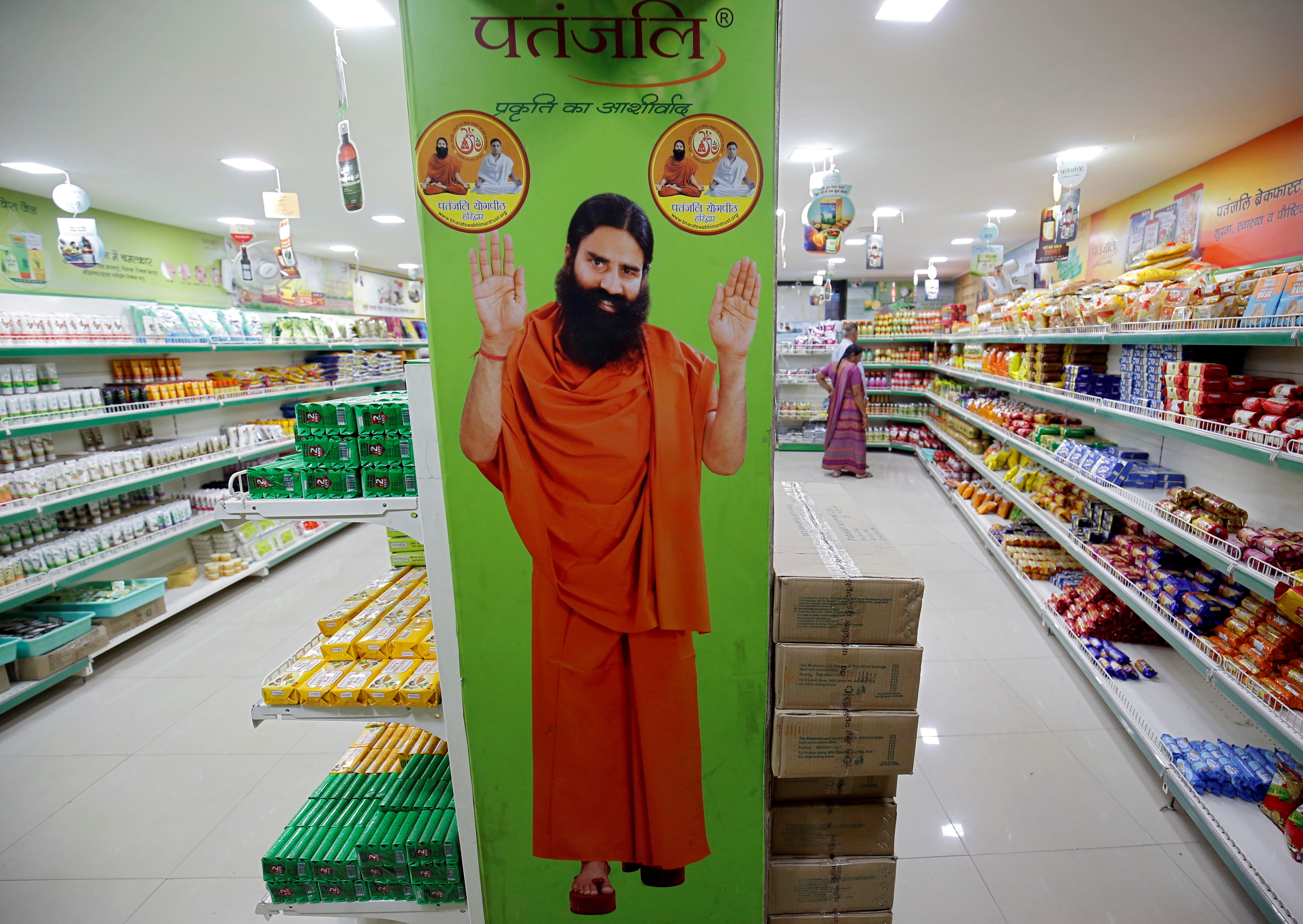 A hoarding with an image of Baba Ramdev is seen inside a Patanjali store in Ahmedabad, India, March 28, 2019. REUTERS/Amit Dave/File Photo