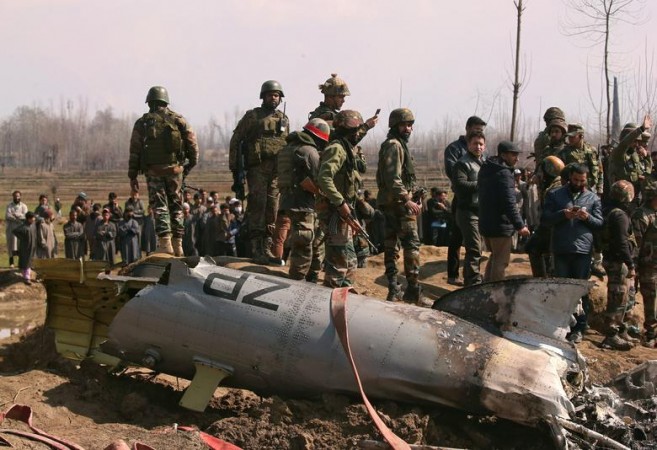 1558799552_indian-soldiers-stand-next-wreckage-indian-air-force-helicopter-after-it-crashed-budgam.jpg