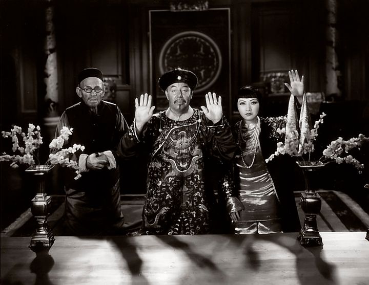 Actress Anna May Wong, at right, and actors E. Alyn Warren and Warner Oland -- two white men portraying Asians -- in a scene from the 1931 movie Daughter of the Dragon.