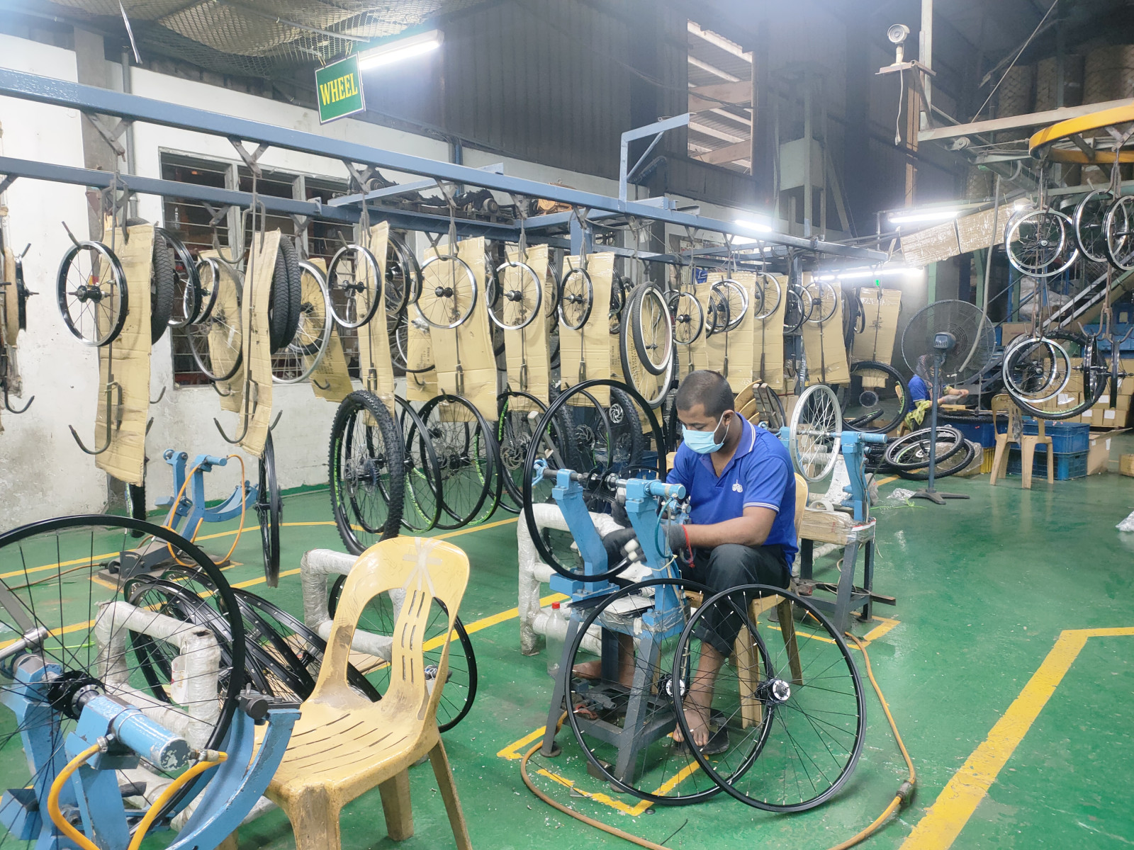 A man works on the fitting of a bicycle tire in a factory. From a very small beginning, Bangladesh is currently the 3rd largest exporter to the European Union (EU) and the 8th largest exporter globally in bicycle manufacturing. Photo: TBS