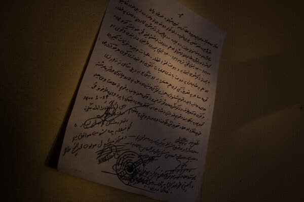 A handwritten note, signed by Taliban and Afghan government officials, outlining a cease-fire in Mehtarlam.