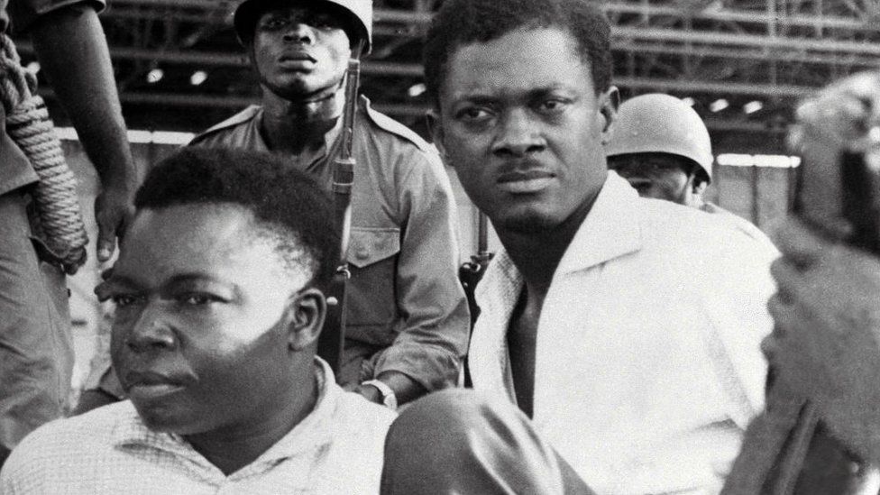 A picture taken in December 1960, shows soldiers guarding Patrice Lumumba (R), Prime Minister of then Congo-Kinshasa, and Joseph Okito (L), vice-president of the Senate, upon their arrest in Leopoldville (now Kinshasa)