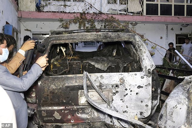 Ahmadi had been getting water jugs out of his car to bring home to his family when the military dropped the Hellfire missile on him. The aftermath above