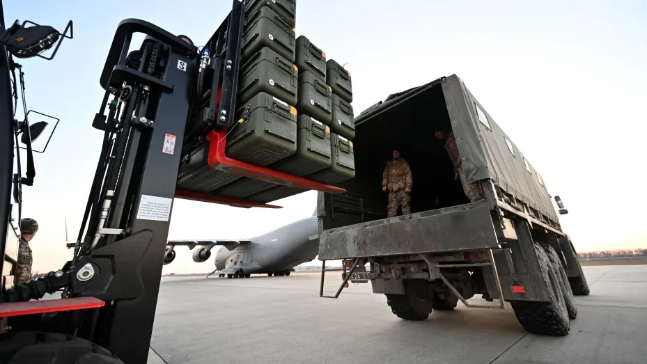 Servicemen of Ukrainian Military Forces move US made FIM-92 Stinger missiles, a man-portable air-defence system (MANPADS), that operates as an infrared homing surface-to-air missile (SAM), and the other military assistance shipped from Lithuania to Boryspil Airport in Kyiv on February 13, 2022. - Ukrainian leader Volodymyr Zelensky will speak to US President Joe Biden in the coming hours, his office said on February 13, 2022, as Western fears grow that Russia is about to invade the ex-Soviet state. The ta