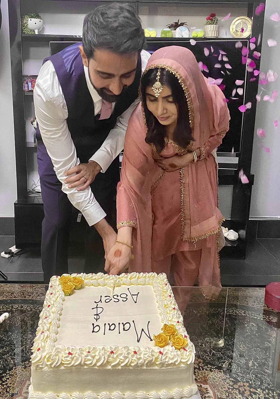 The newlyweds cutting the wedding cake shown in a photograph posted by Asser Malik