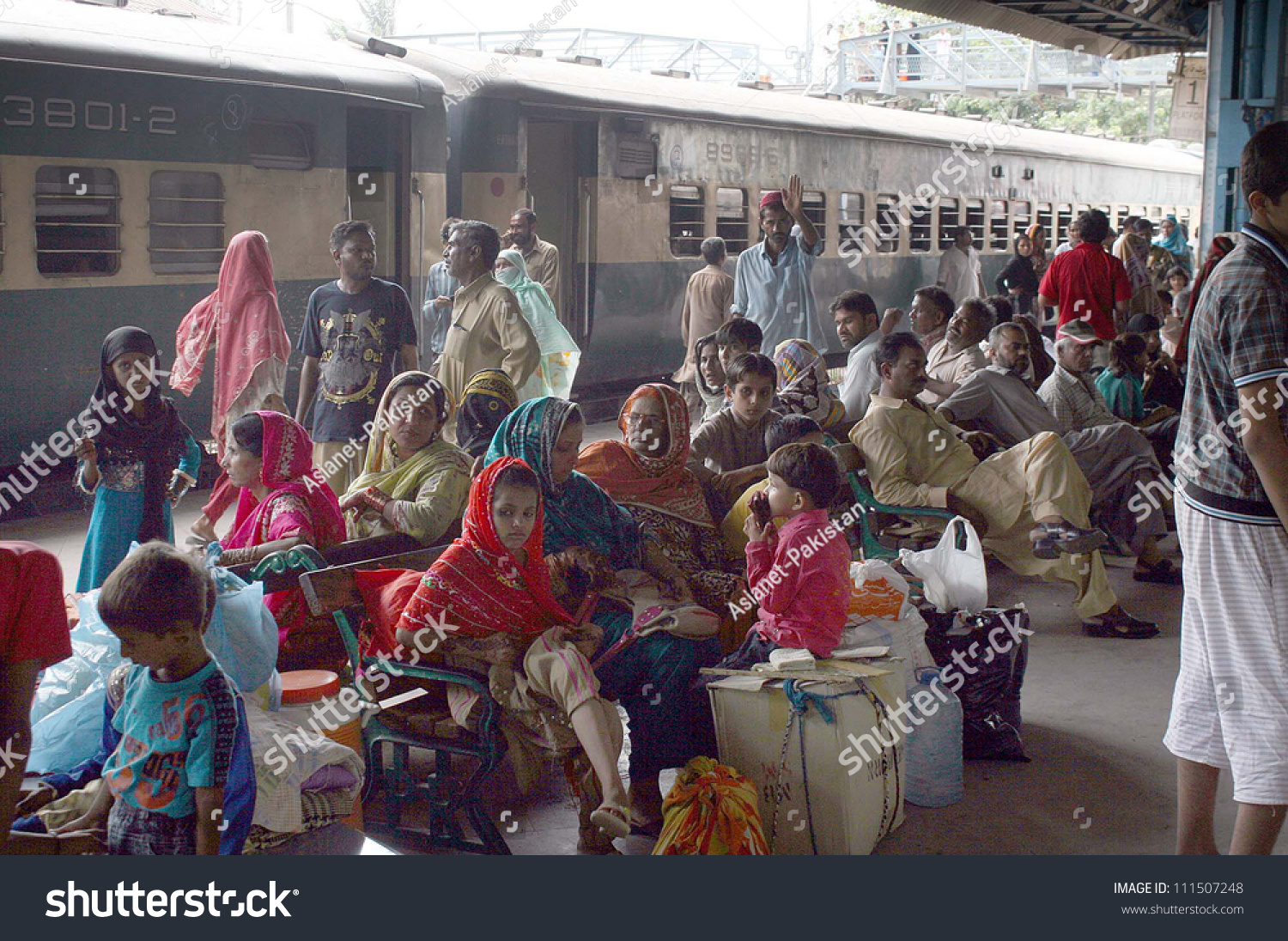 stock-photo-karachi-pakistan-aug-passengers-with-their-bags-gather-at-platform-as-trains-are-late-from-111507248.jpg