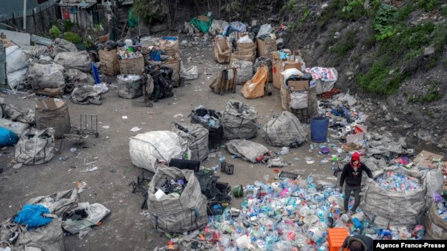 Afghan refugees collect waste at a makeshift dumping ground on Nov. 18, 2021, in Istanbul.