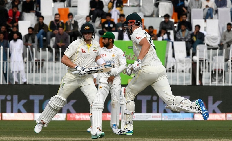 Australia's Steven Smith (L) and Cameron Green run between the wickets during the fourth day of the first Test match between Pakistan and Australia at the Rawalpindi Cricket Stadium in Rawalpindi on Monday. — AFP