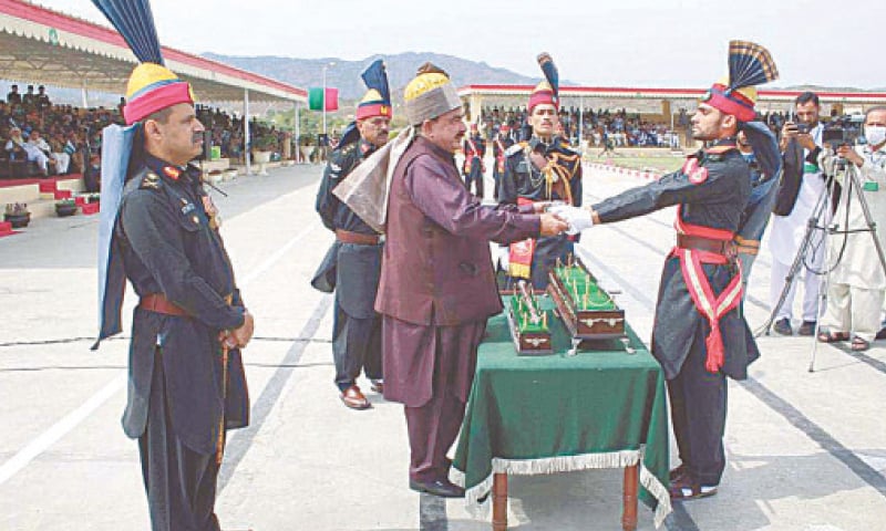 Interior Minister Sheikh Rashid Ahmad giving away the Sword of Honour to a recruit at the passing-out ceremony of Frontier Corps (North) at the Scouts Training Academy, Warsak, on Sunday.—APP