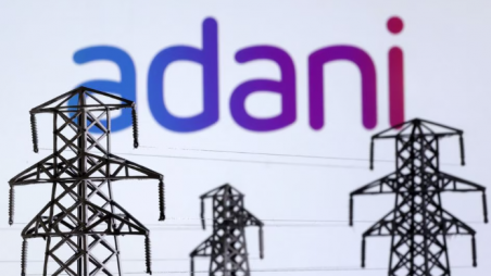 Electric power transmission pylon miniatures and Adani Green Energy logo are seen in this illustration taken, December 9, 2022. REUTERS/Dado Ruvic/Illustration/Files