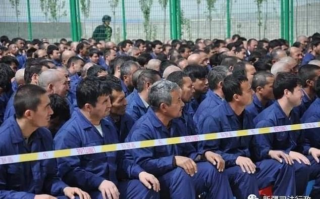 A survivor of one of China's barbaric modern-day concentration camps has revealed the beatings, rapes and 'disappearances' she witnessed behind the barbed wire. Members of the Uyghur ethnic minority are pictured in a camp in Lop County, Xinjiang, in April 2017