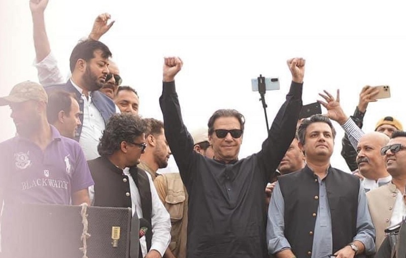 PTI Chairman Imran Khan gestures at his supporters during a stopover of his caravan in Gakharmandi on Wednesday. — PTI/Twitter