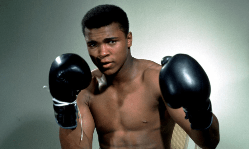 Muhammad Ali posing with his boxing gloves. — Reuters/File