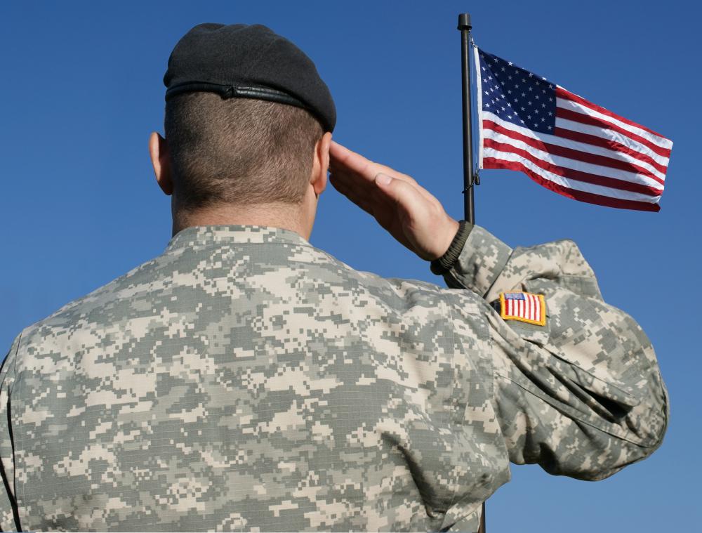 us-soldier-saluting-the-american-flag-against-a-blue-sky.jpg