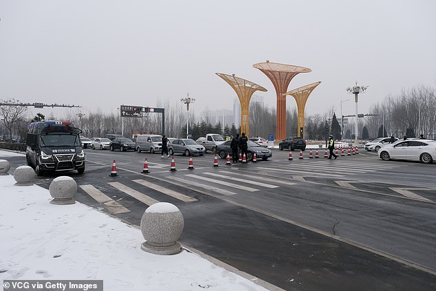 Policemen control traffic at Anxin County after new Covid-19 cases were reported on January 24 in Xiongan New Area