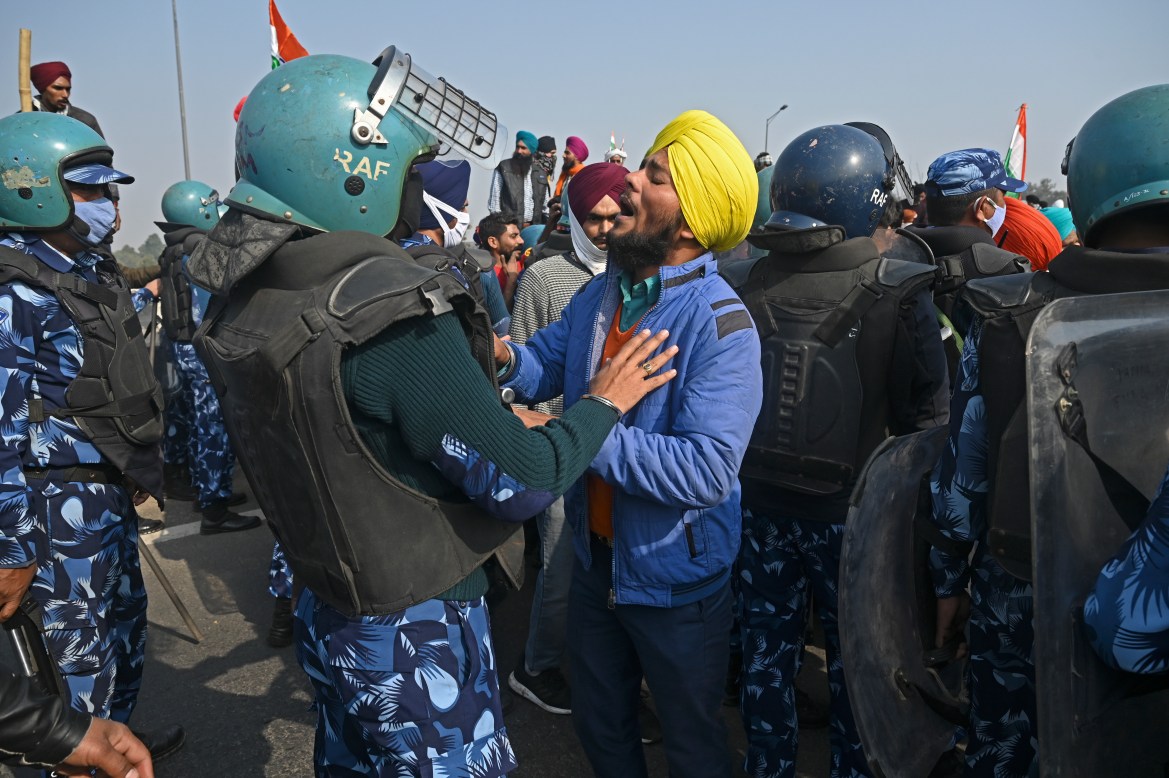 Farmers scuffle with security personnel during the rally. Police launched one of their largest security operations in years to stop the demonstrators. [Sajjad Hussain/AFP]