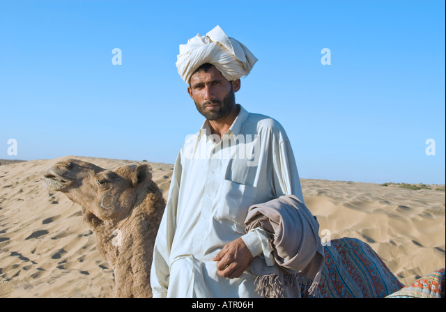 portrait-of-a-handsome-muslim-camel-driver-with-his-camel-in-the-thar-atr06h.jpg