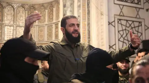 AFP Hayat Tahrir al-Sham (HTS) leader Abu Mohammed al-Jolani speaks to a crowd at the Umayyad Mosque in Damascus, Syria, after the overthrow of President Bashar al-Assad (8 December 2024)