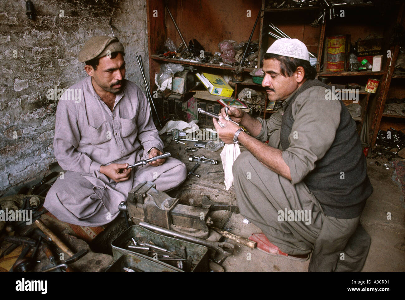 pakistan-nwfp-darra-adam-khel-men-making-rifle-bolts-A90R91.jpg