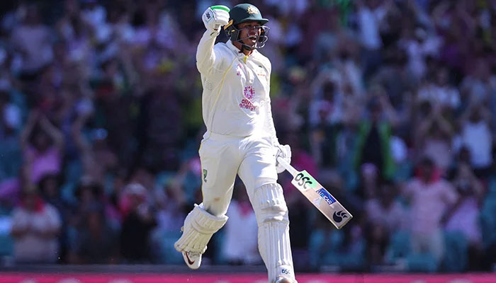 Australian opener Usman Khawaja celebrates after smashing century on day four of the fourth Ashes cricket test between Australia and England at the Sydney Cricket Ground (SCG) on January 8, 2022. — AFP