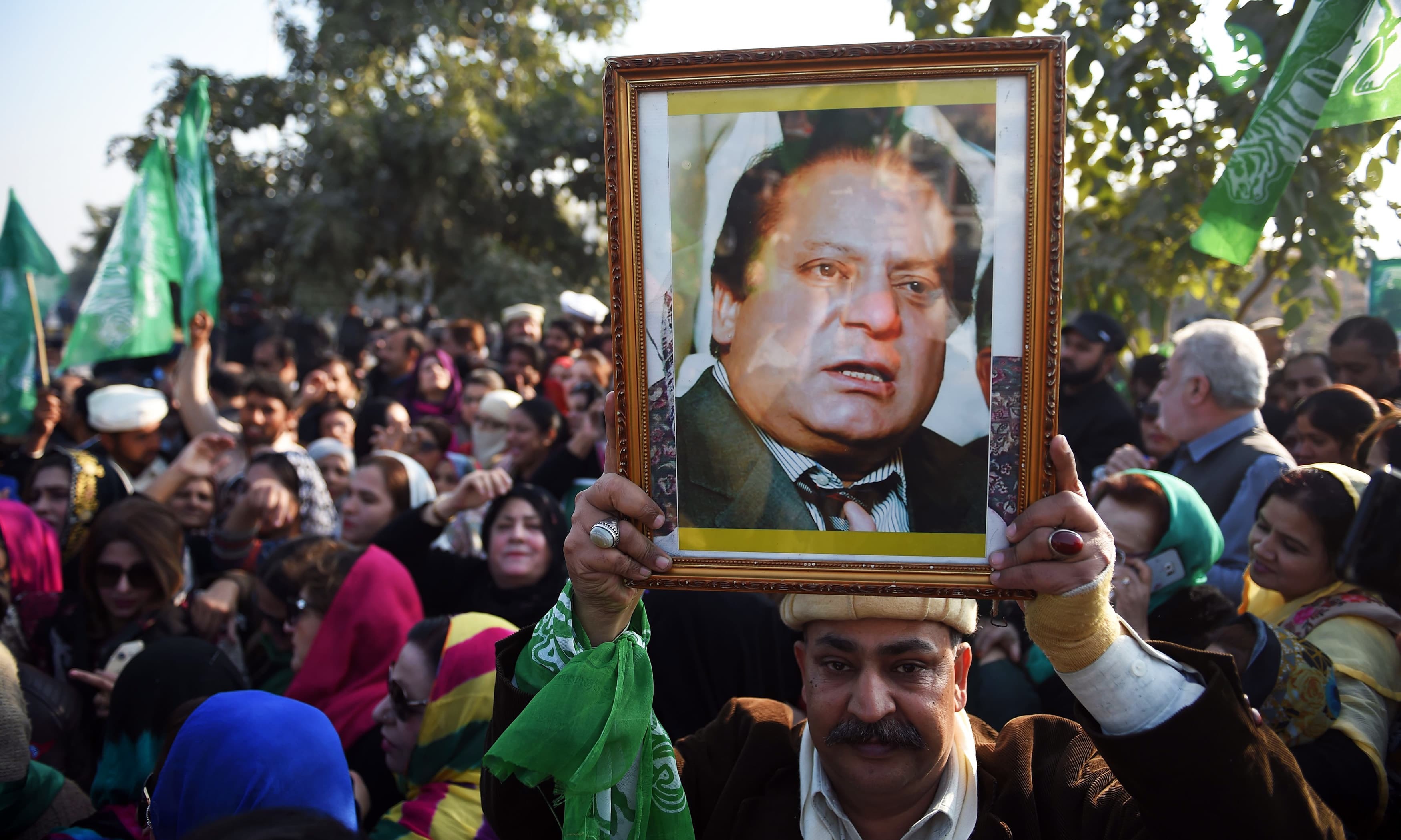 PML-N supporters gather outside the anti-corruption court in Islamabad, ahead of the court verdict against Nawaz in the Al-Azizia and Flagship Investment cases. — AFP
